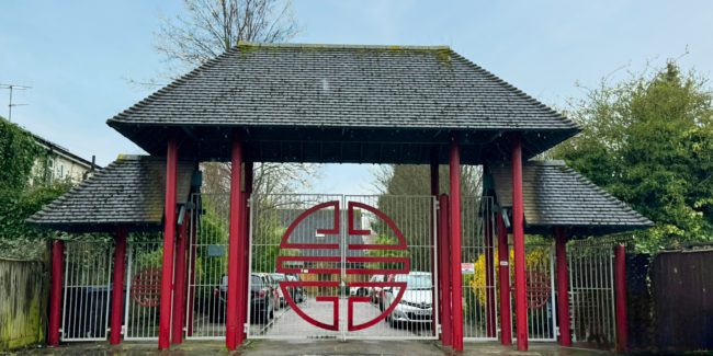 red metal gates with tiles roof